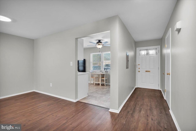 foyer entrance featuring ceiling fan, dark hardwood / wood-style floors, and electric panel