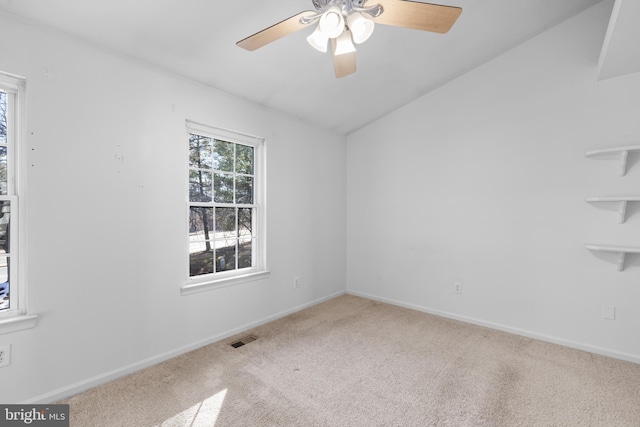 carpeted empty room with lofted ceiling and ceiling fan