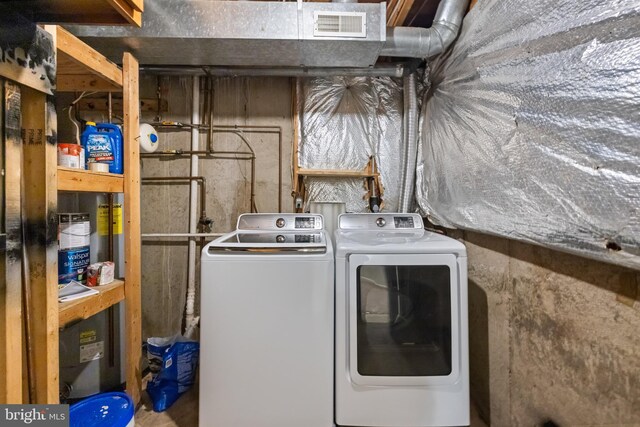 clothes washing area with washing machine and clothes dryer