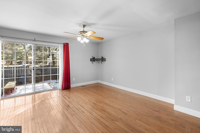 spare room featuring wood-type flooring and ceiling fan