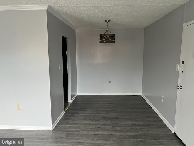 unfurnished dining area with dark hardwood / wood-style flooring and a textured ceiling