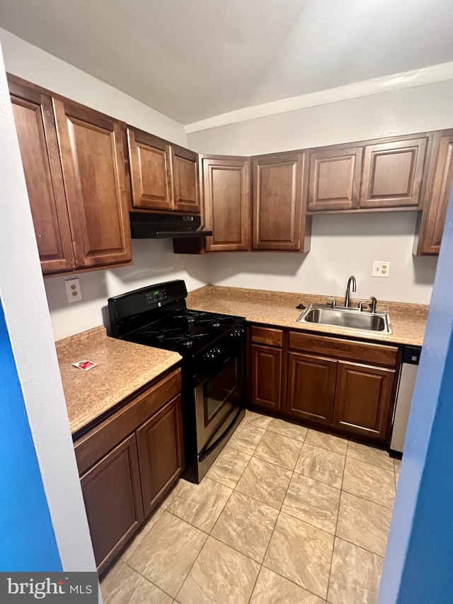 kitchen with dishwasher, dark brown cabinets, sink, and range with gas cooktop