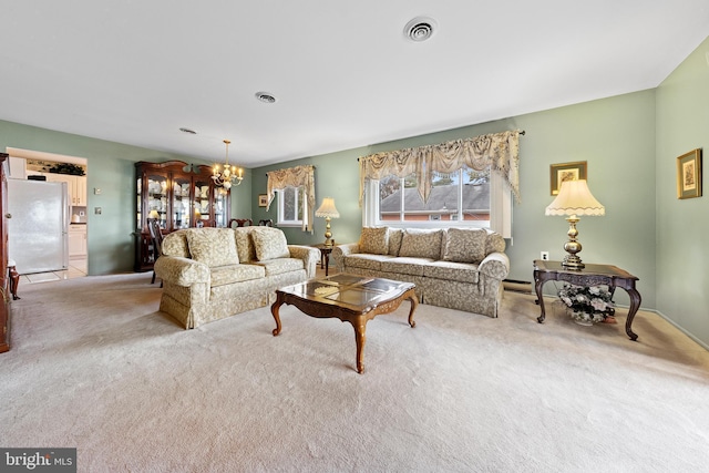 living room with light colored carpet and an inviting chandelier