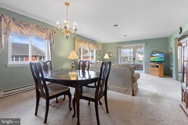 dining room featuring light colored carpet, a baseboard radiator, and an inviting chandelier