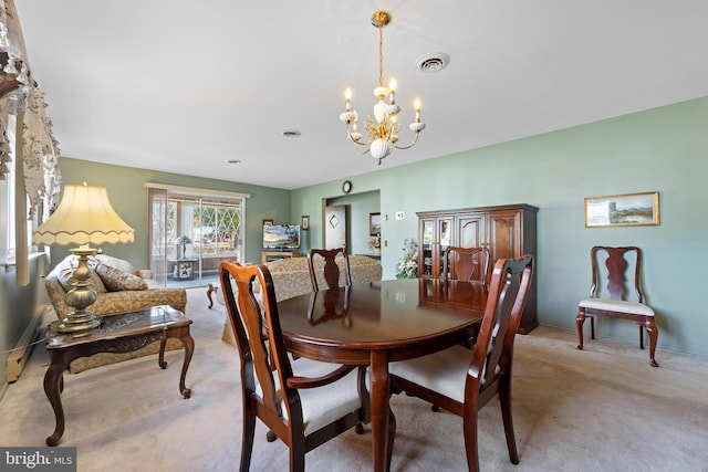 dining room featuring light carpet and a notable chandelier