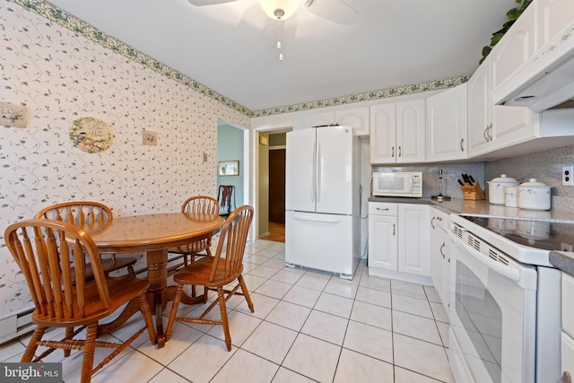 kitchen featuring white cabinets, light tile patterned floors, white appliances, and ventilation hood