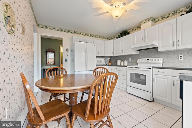 kitchen with decorative backsplash, white appliances, ceiling fan, white cabinetry, and light tile patterned flooring