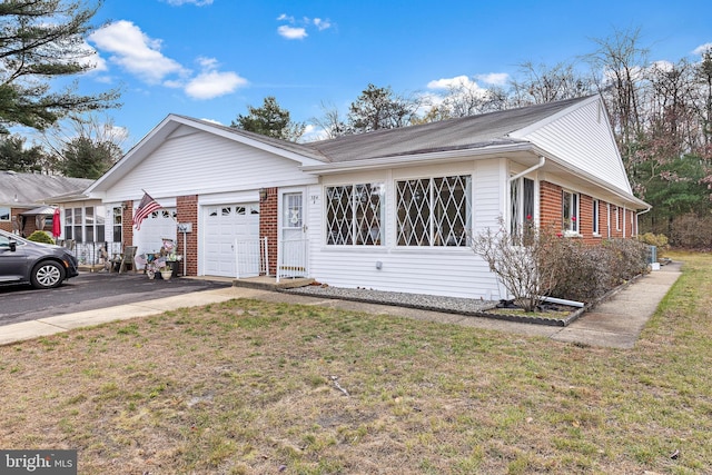 single story home with a garage and a front yard