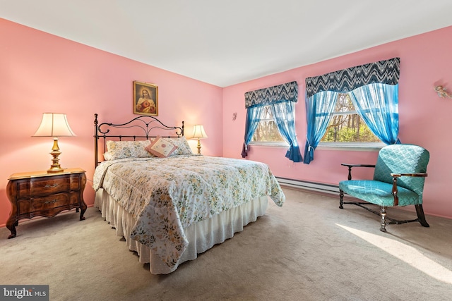 bedroom featuring light colored carpet and a baseboard heating unit