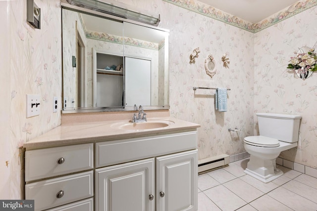 bathroom featuring tile patterned floors, toilet, vanity, and a baseboard heating unit