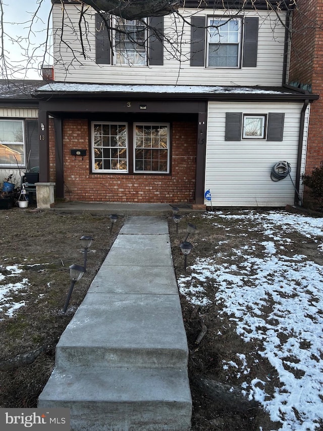 view of snow covered property entrance