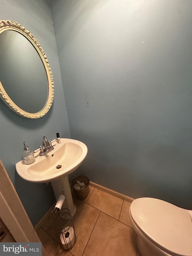 bathroom with sink, tile patterned flooring, and toilet