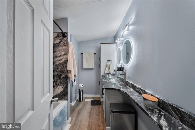 2612 Oakwood Ct, East Stroudsburg, PA 18302 - bathroom featuring vanity, a textured ceiling, bathing tub / shower combination, wood-type flooring, and lofted ceiling