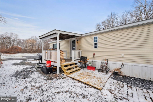 snow covered property with a deck