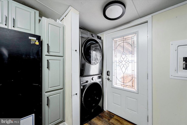 2612 Oakwood Ct, East Stroudsburg, PA 18302 - clothes washing area featuring cabinets, electric panel, dark hardwood / wood-style floors, and stacked washer / dryer