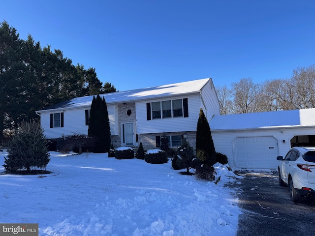 raised ranch with brick siding and an attached garage