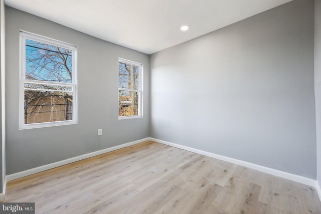 unfurnished room with light hardwood / wood-style flooring