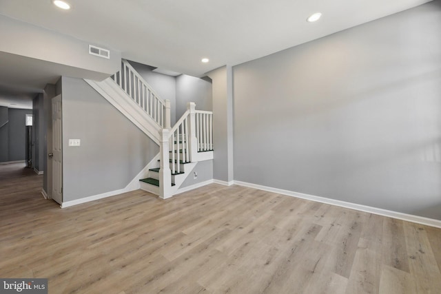 stairs with hardwood / wood-style flooring