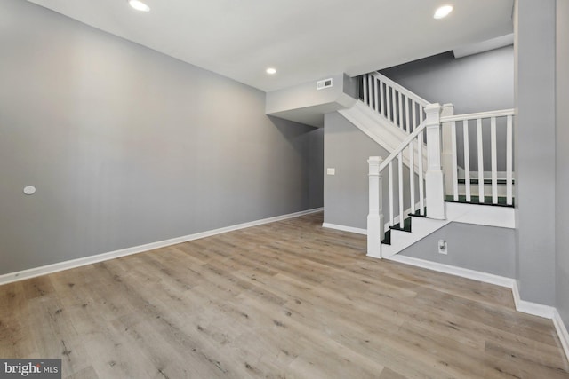 stairs featuring hardwood / wood-style floors