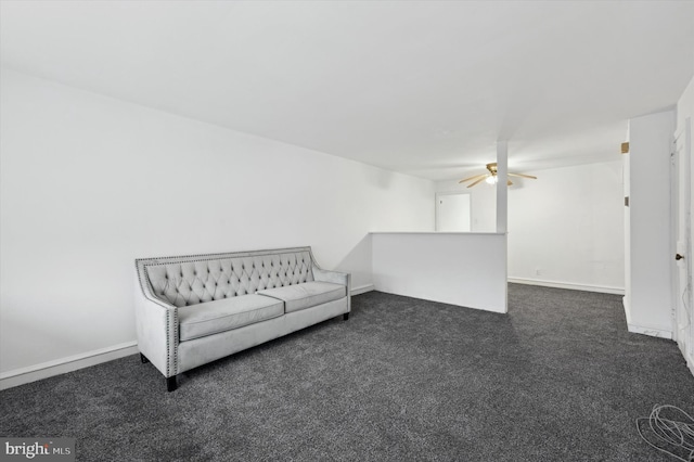 unfurnished room featuring ceiling fan and dark carpet