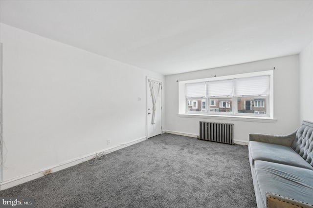 unfurnished living room featuring radiator heating unit and carpet floors