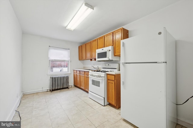 kitchen with radiator heating unit, white appliances, and sink