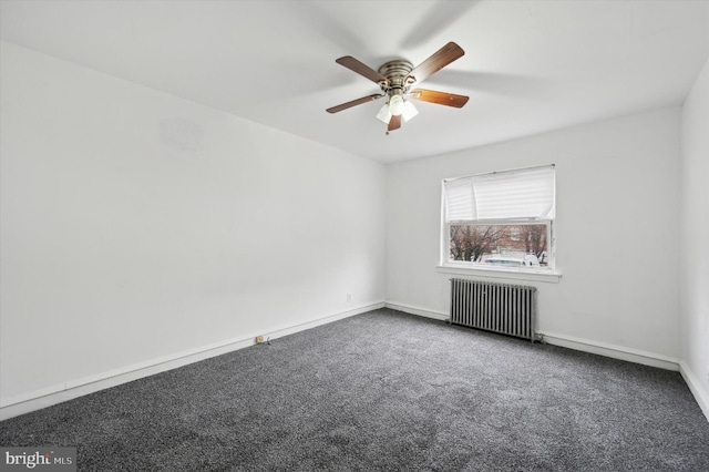 empty room featuring carpet flooring, ceiling fan, and radiator