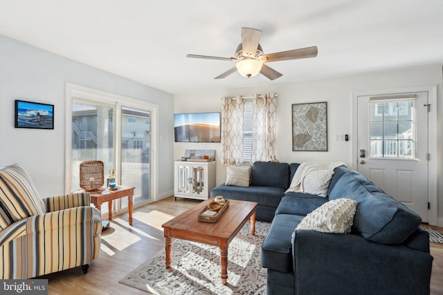 living room featuring light hardwood / wood-style flooring and ceiling fan