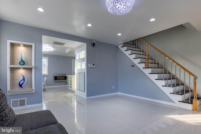 stairway featuring a chandelier