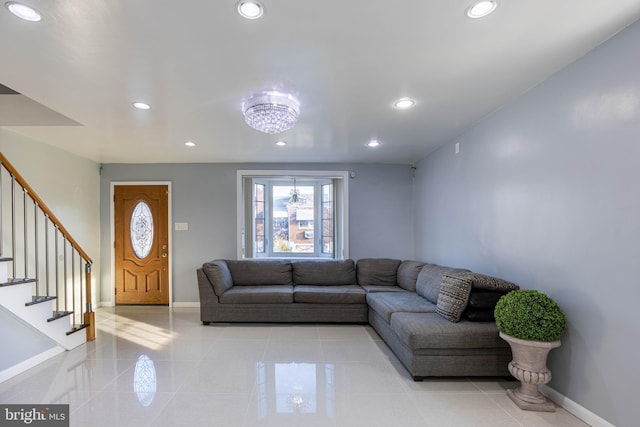 tiled living room with a chandelier