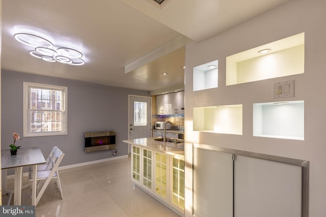 kitchen with light tile patterned flooring and heating unit