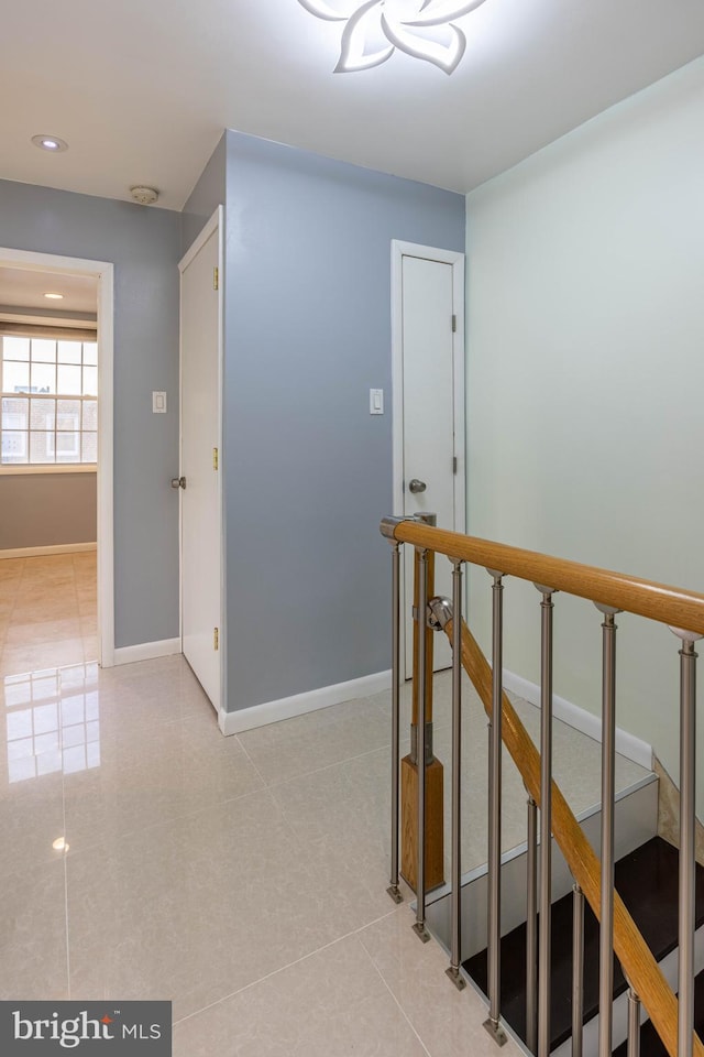 corridor with light tile patterned floors