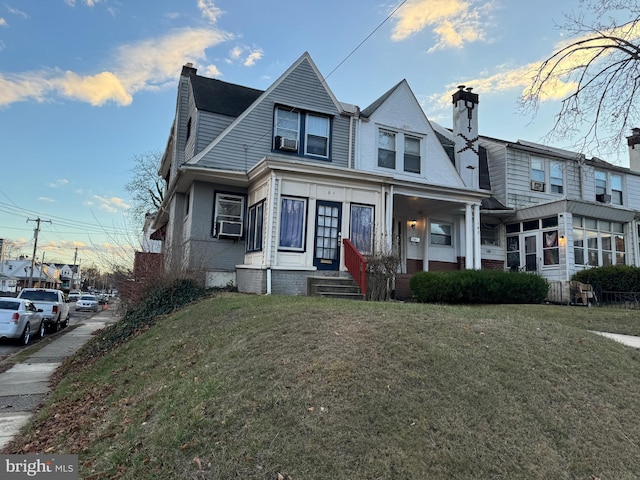 view of front of home featuring a front yard and cooling unit