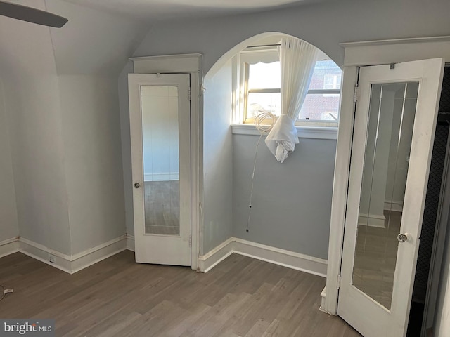 doorway to outside with hardwood / wood-style flooring and lofted ceiling