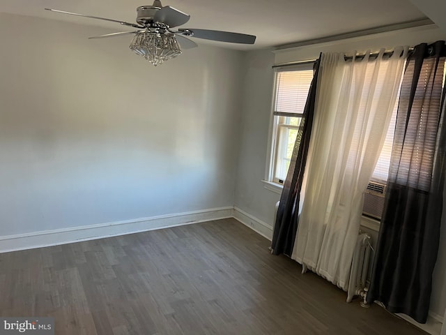 spare room with ceiling fan and dark hardwood / wood-style flooring