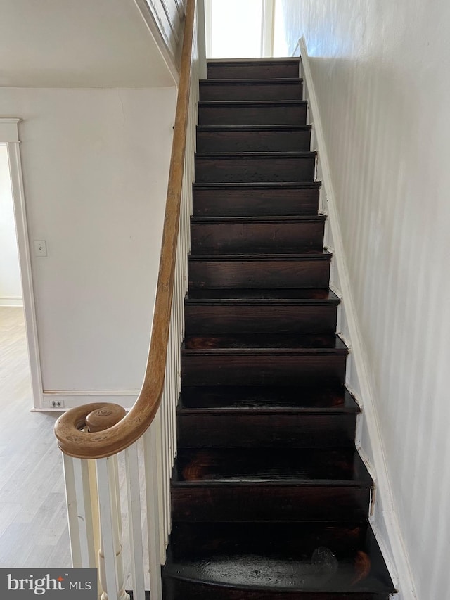 stairs with wood-type flooring