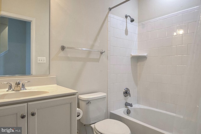 full bathroom featuring vanity, toilet, and tiled shower / bath combo