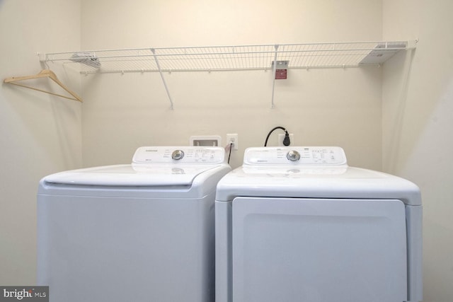 clothes washing area with washing machine and clothes dryer