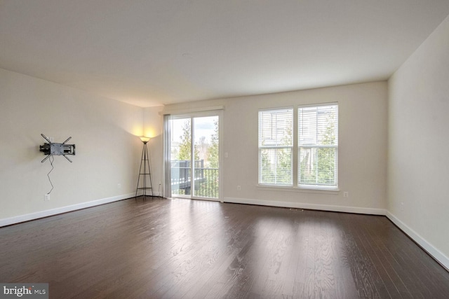 unfurnished room with dark hardwood / wood-style flooring