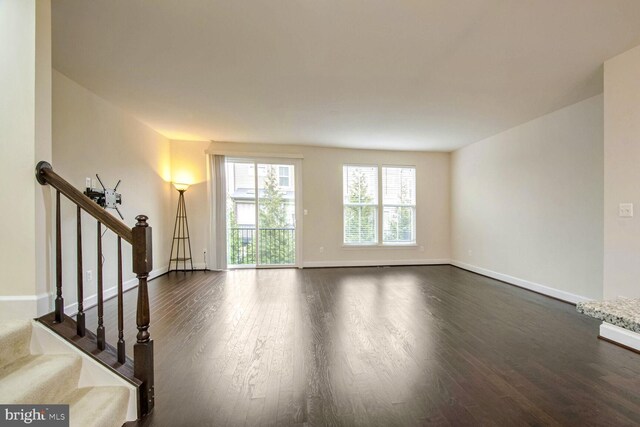 unfurnished room with dark hardwood / wood-style flooring