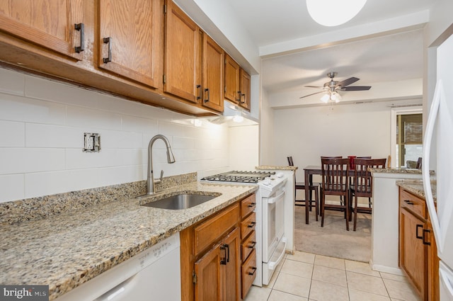 kitchen with white appliances, sink, ceiling fan, tasteful backsplash, and light tile patterned flooring