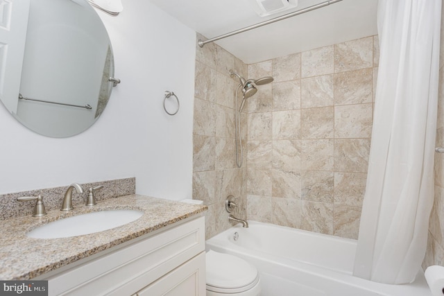 full bathroom featuring vanity, shower / tub combo, and toilet