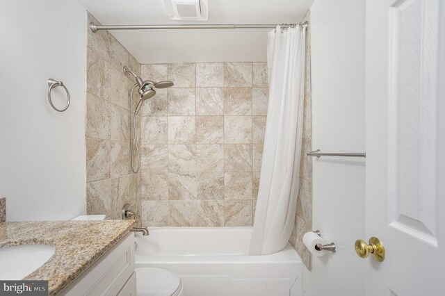 full bathroom with vanity, toilet, and shower / tub combo