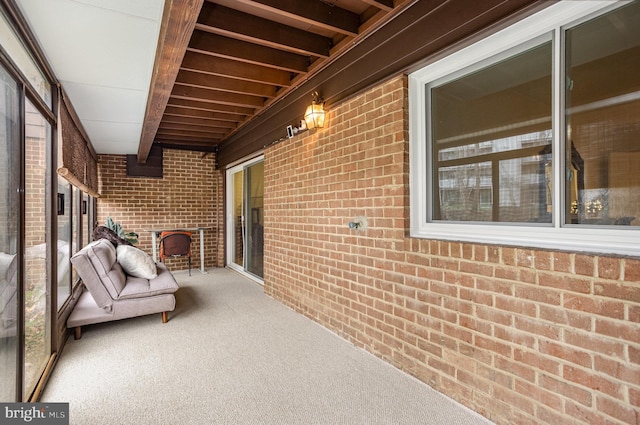 unfurnished sunroom with beam ceiling