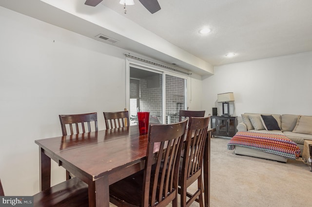 dining area with carpet flooring and ceiling fan