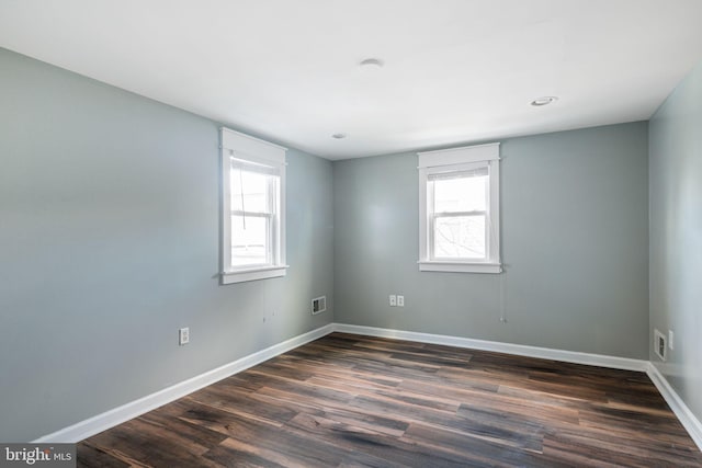 empty room with dark hardwood / wood-style flooring