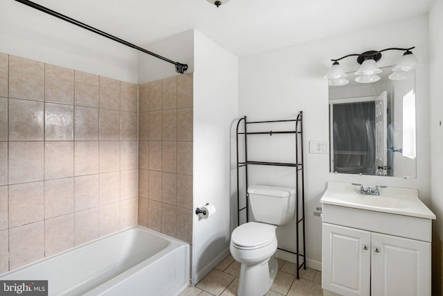 full bathroom featuring tiled shower / bath, tile patterned flooring, vanity, and toilet