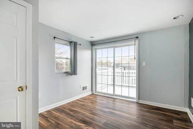 unfurnished room with dark hardwood / wood-style flooring