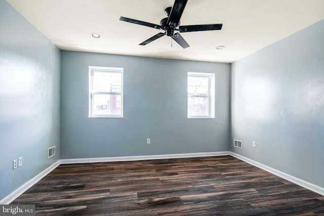 unfurnished room featuring dark hardwood / wood-style flooring, ceiling fan, and a healthy amount of sunlight