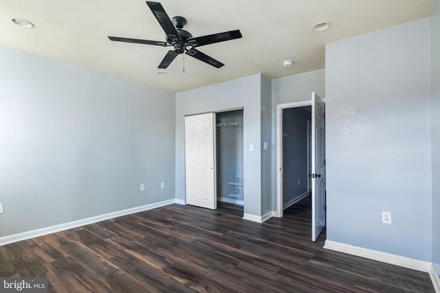 unfurnished bedroom featuring a closet, dark hardwood / wood-style floors, and ceiling fan